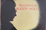 Image of the 1963 Album cover of Coral recording ‘Reminiscing’ by Buddy Holly, with photo of Buddy Holly seated in a airplane near the window