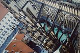 a view from above a very tall and architecturally precise church in Prague