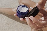 An open jar of moisturiser skincare by Mathilde Langevin