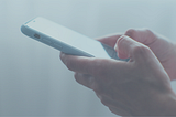 person typing on smartphone