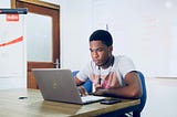 A writer editing a draft on his laptop