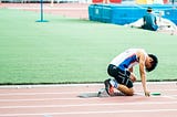 Runner crouches at the starting blocks