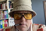 Photo of Rob in his Hunter S Thompson bucket hat and big glasses.