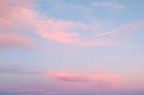 a blue sky with some pinkish clouds