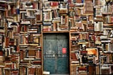 leather-bound books crammed into shelving covering a wall