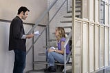 Bill Hader standing, and Sarah Winkler sat on some stairs, reading lines, in the second season of Barry.