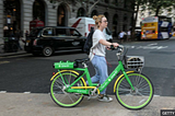 Woman with an e-bike along the street