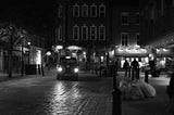 A London black taxi at night on a quiet cobbled street