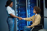 Engineer shaking hands with server worker in data center after a succesfull disaster recovery by joel wembo