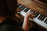 woman playing yamaha piano