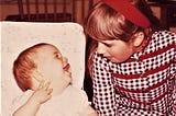 The author as a baby laughing at her older sister.