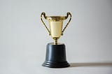 a gold trophy on a white background