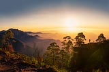 Silhouette of a woman watching the sunrise at Dolphin’s nose in Kodaikanal, Tamil Nadu.