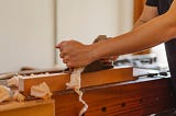 Someone working on wood in a workshop