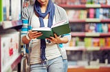 College student reading in a library.