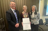 Sarah Hall (center) receives the Meritorious Service Award with Pacific Region Deputy Regional Director Bridget Fahey (right) and Regional Director Hugh Morrison (left).