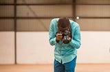 Boateng Sekyere, a photographer, looking through his camera’s viewfinder