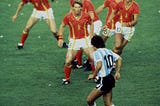 Diego Maradona of Argentina is confronted by Belgium players during the 1982 World Cup