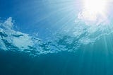 Sun blazing onto water, photo shot from under the surface