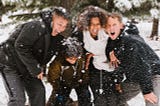 Family laughing together in the snow