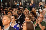 Crowd of people clapping