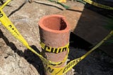 A section of our old clay sewer pipe used to tape off repairs to our house.