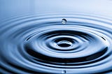 A drop of water causes a ripple effect in a pool of water