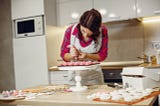 Woman decorating cupcakes