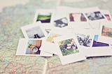 Pile of photos on a map.