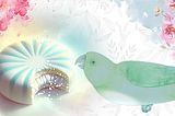 A beautiful collage in turquoises and pinks, flowers surround a glistening white peppermint pattie with a turquoise sunburst. A teal-colored parrot is leaning towards it. It looks like it want to take a taste.