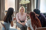 Woman in a circle being “managed” with love