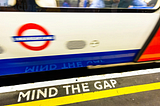 A London Underground tube, and “Mind The Gap” on platform.
