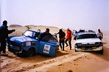 Two cars stuck in the desert sand