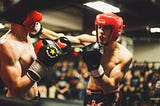 Two boxers in a boxing ring.