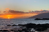West Maui rises in the distance in a sunset photo taken from Kamaole Beach Park III.