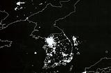Korean Peninsula at night. South Korea is filled with lights and energy and vitality and a booming economy; North Korea is dark.