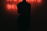 Woman in front of neon sign