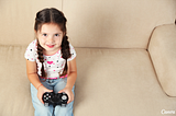 A five-year-old girl holding a video game controller