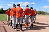 We need to find a way to make baseball more affordable to all demographics. A bunch of white players on a baseball field.