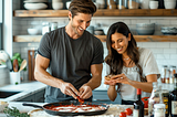 A couple enjoy cooking.