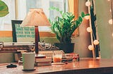 An antique typewriter and a cup of coffee on a wooden desk.