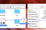 A screenshot of two Finder windows on a macOS system. The left window is open to the ‘Documents’ folder, displaying various files and folders, including ‘Kate-comments,’ which is highlighted and being dragged. The right window is open to the ‘Measuring Usability’ folder, showing files like ‘2014–2–3-MeasuringUX.pptx’ and ‘ROI for Usability…dition.pdf.’ A blue dashed arrow indicates that ‘Kate-comments’ is being moved from ‘Documents’ to ‘Measuring Usability.’