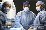 3 surgeon doctors — 1 man and 2 women, at the surgery table, wearing masks and feeling smart