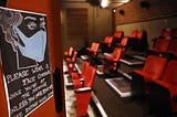 A sign reminding people to wear a face mask while in a small independent cinema.