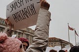 A protester with a sign saying “smash the patriarchy”