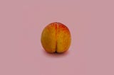 peach in the shape of a butt