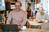 Man laughing at his computer