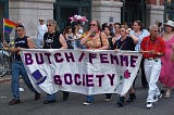 A group of butch and femme lesbians carrying a banner that says Butch/Femme Society at the New York gay pride parade