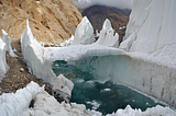 Melting river and frozen bridge in one of Central Asia glaciers