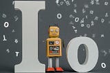 Robot stading next the Io word with letters flying around